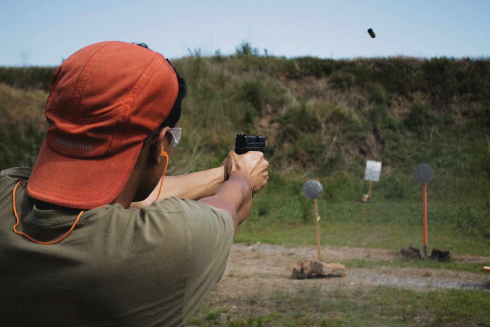 Student shooting pistol at steel targets