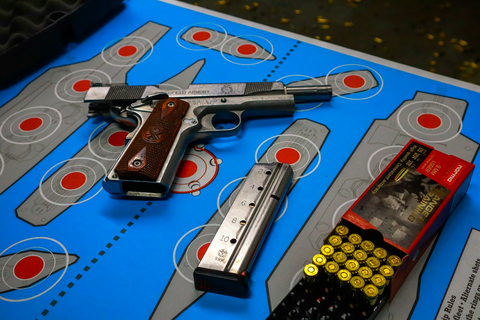 Pistol, magazine and ammunition on a target